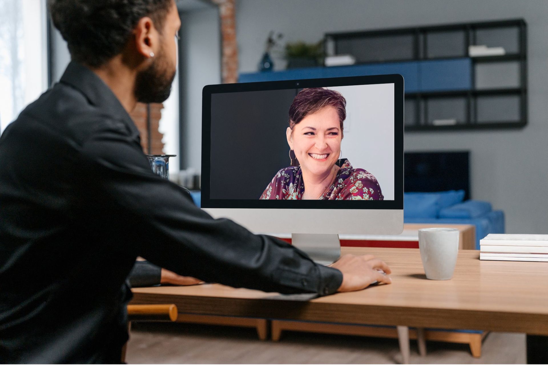 Man looking Rhonda Bell on a large iMac desktop computer